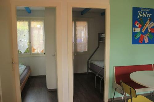 Zimmer mit einem Zimmer mit einem Tisch und einem Bett in der Unterkunft appartement confort 5 personnes in Grandson