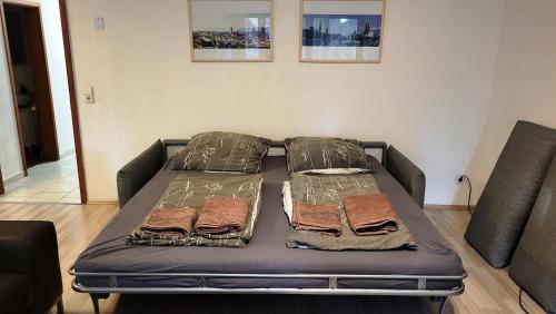 a bed in a living room with two pillows at Apartment König in Tübingen