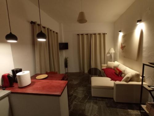 a living room with a white couch and a table at PALACE Sea view in Megála Khoráfia