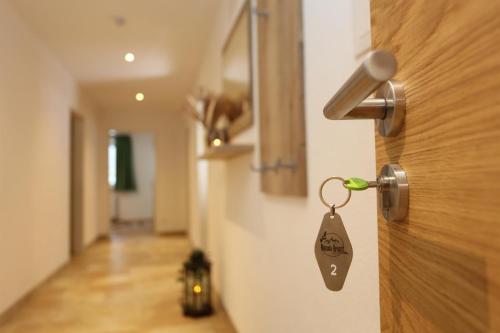 a lock on a door with a key on it at Natura Aparts in Stanzach