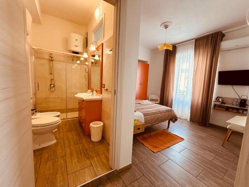 ein Bad mit einem WC, einem Waschbecken und einem Bett in der Unterkunft Sweet Rooms Cagliari in Cagliari