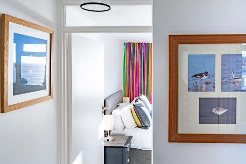 a room with a bed and a picture on the wall at 19 Undercliffe in Felixstowe