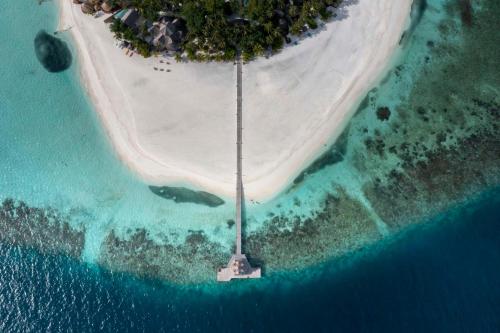 an aerial view of an island in the ocean at Banyan Tree Vabbinfaru in Male City