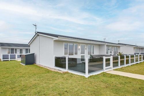 a white house with a large yard at Host & Stay - Sea View Road in Bessingby