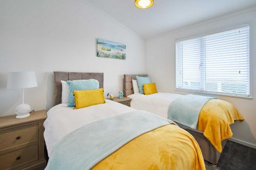 a bedroom with two beds and a window at Host & Stay - Sea View Road in Bessingby