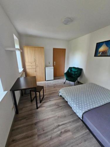 1 dormitorio con cama, escritorio y mesa en Private Room with Private Bathroom, en Rostock