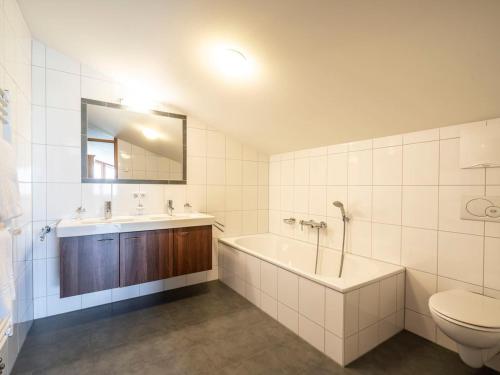 La salle de bains est pourvue d'une baignoire, d'un lavabo et de toilettes. dans l'établissement Landal Chalet Matin, à Bürserberg