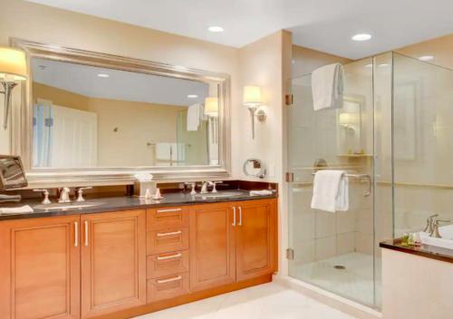 a bathroom with a shower and a sink and a mirror at Luxury Studio With Balcony At Las Vegas in Las Vegas