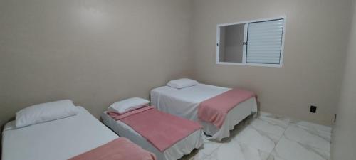 Llit o llits en una habitació de Área de Lazer Macaúba Sabiá