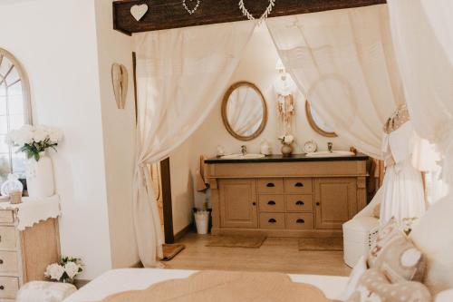 a bedroom with a sink and a mirror at Chez Géraldine in Montels