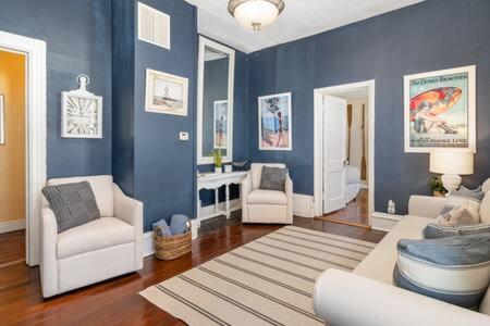 a living room with blue walls and white furniture at Downstairs 2 Bedroom Apt- Pet Friendly- walking distance to beach & shops in Michigan City