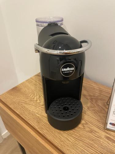 a black coffee maker sitting on a table at Almarea B&B Trani in Trani