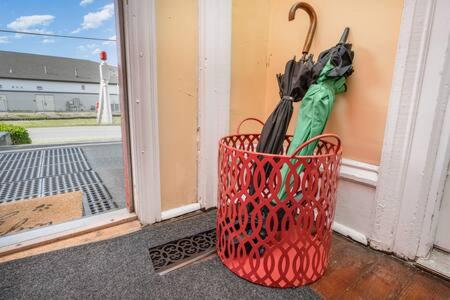 a basket full of umbrellas sitting on a porch at Beautiful downstairs 1bed 1bth charmer- Pet Friendly in Michigan City