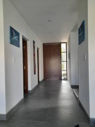 a hallway of a building with a door and a hallwayngthngthngthngthngth at Yunka House, Salta in Vaqueros