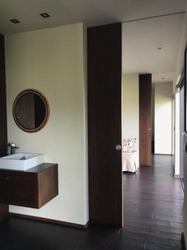a bathroom with a sink and a mirror on the wall at Casa Nova in Guimarães
