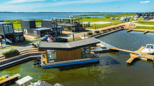 a house boat docked at a dock in the water at Twin Boat in Ekerö