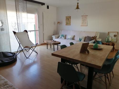 a living room with a table and a couch at El Vergel del Piedra in Munébrega