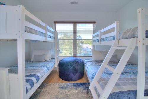 a bedroom with two bunk beds and a window at Inlet Escape in Myrtle Beach