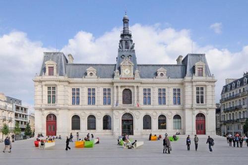 a large building with a clock tower on top of it at Le Bon Séjour, studio à 2 pas du Futuroscope in Chasseneuil-du-Poitou