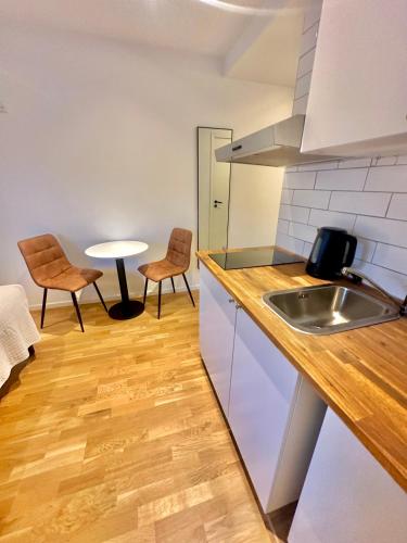 a kitchen with a sink and a table and chairs at Edsviken Hotell AB in Stockholm