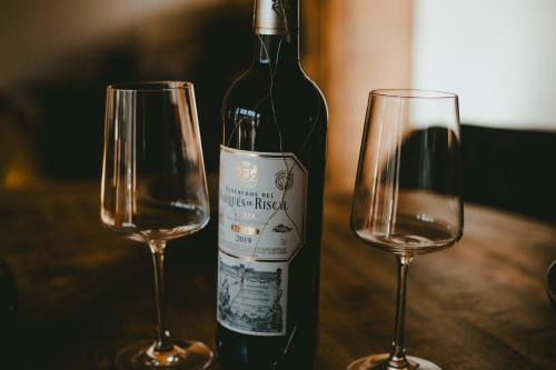 a bottle of wine and two glasses on a table at Ferienwohnung Katie in Hopfgarten im Brixental