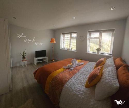 a bedroom with a large bed with a hello might korea sign at Spa Serviced Apartments LUNA R&R 