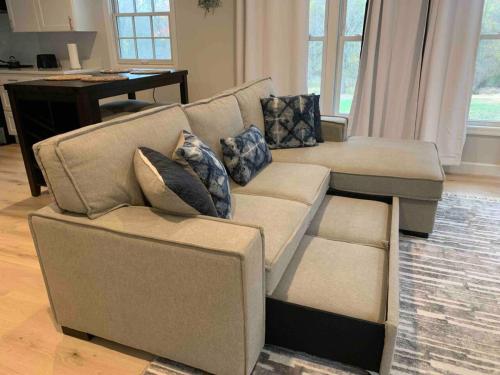 a couch and a chair in a living room at Serene Lush 2BR Gem, on 1 acre Silver Spring in Silver Spring