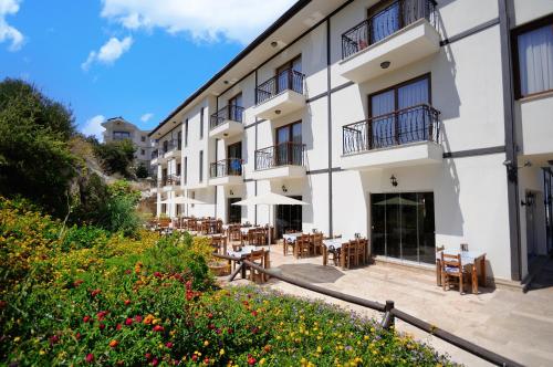 a view of a building with tables and chairs at Doada Hotel in Datca