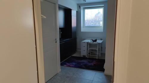 a small bathroom with a window and a small table at 2- bed Apartment in Sollentuna in Sollentuna