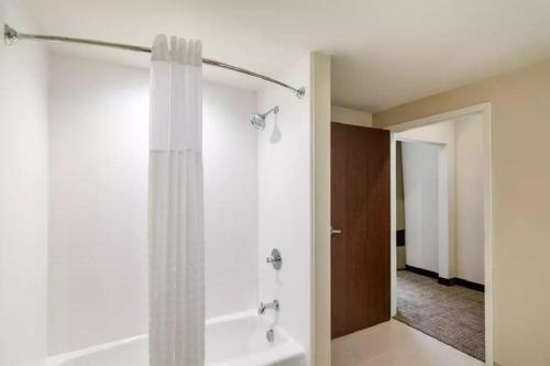 a bathroom with a shower with a shower curtain at Comfort Suites Meridian and I-40 in Oklahoma City