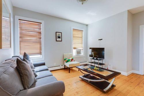 a living room with a couch and a coffee table at NEW! Boston Condo Near MBTA, 3Mi to Fenway ! (U3) in Boston