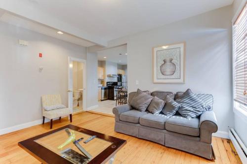 a living room with a couch and a table at NEW! Boston Condo Near MBTA, 3Mi to Fenway ! (U3) in Boston