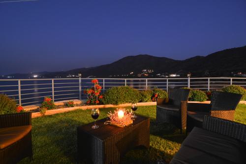 a patio with chairs and a table with a candle at Kalli Villa in Pomos