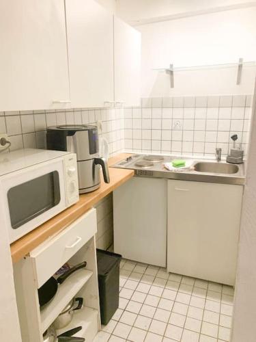 a kitchen with a microwave and a sink at Countryapartment Eifel in Kall