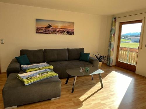 a living room with a couch and a table at Haus Allgäu Ruh in Görisried
