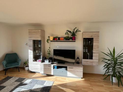a living room with a entertainment center with a flat screen tv at Haus Allgäu Ruh in Görisried