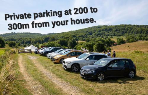 a row of parked cars parked in a field at Casa Strâmbă in Zece Hotare