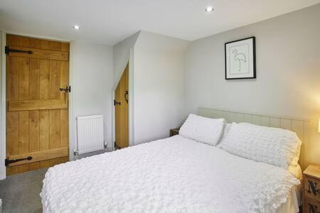 a bedroom with a white bed and a wooden door at Host & Stay - Cote in Consett