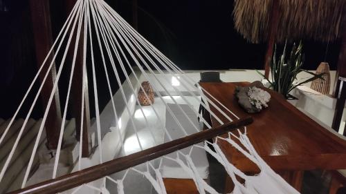 a white staircase with a wooden table in a room at Rincón del mar Veleros Hotel in San Onofre