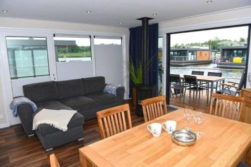 een woonkamer met een bank en een tafel bij Hausboot Dolce Vita in Klitten