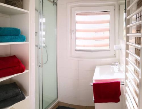 a white bathroom with a sink and a window at Hausboot Schatzinsel in Klitten