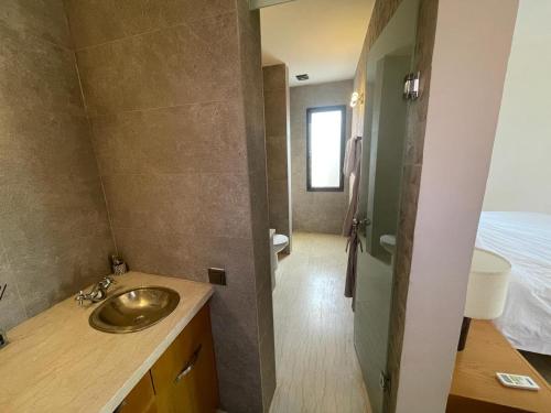 a bathroom with a sink and a shower at Kech-Montana in Mzoudia