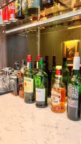 a bunch of bottles of alcohol sitting on a counter at The Portico Hotel in London