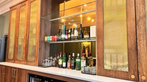 a bar with bottles of alcohol on a shelf at The Portico Hotel in London