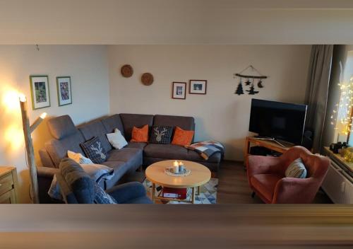 a living room with a couch and a table at Ferienwohnung HEXE mit Komfort **** in Sankt Andreasberg