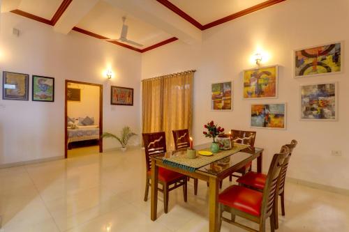 a dining room with a table and chairs at JAQK Holidays - 9BHK Villa for Big Groups, Private Pool-WiFi-Cartaker-Parking, North Goa in Baga