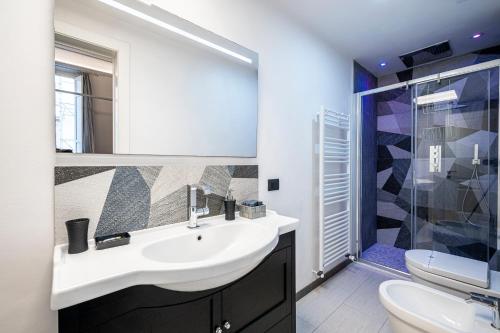 a bathroom with a sink and a toilet and a shower at Cherubini Palace Thematic Apartment in Florence