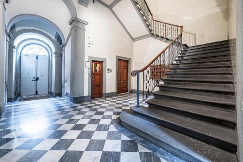 a staircase in a building with a checkered floor at Cherubini Palace Thematic Apartment in Florence