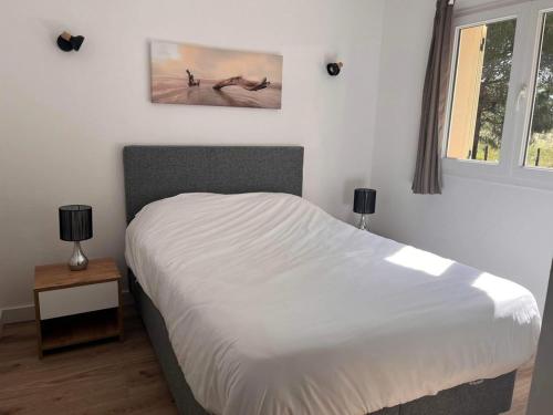 une chambre avec un lit blanc et une fenêtre dans l'établissement Tamaricciu di cala rossa, à Lecci