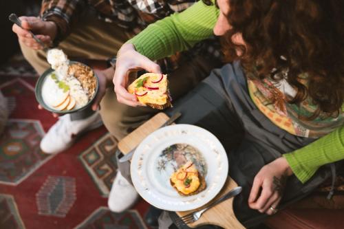 a group of people sitting around a table eating food at Hostel Ani&Haakien in Rotterdam